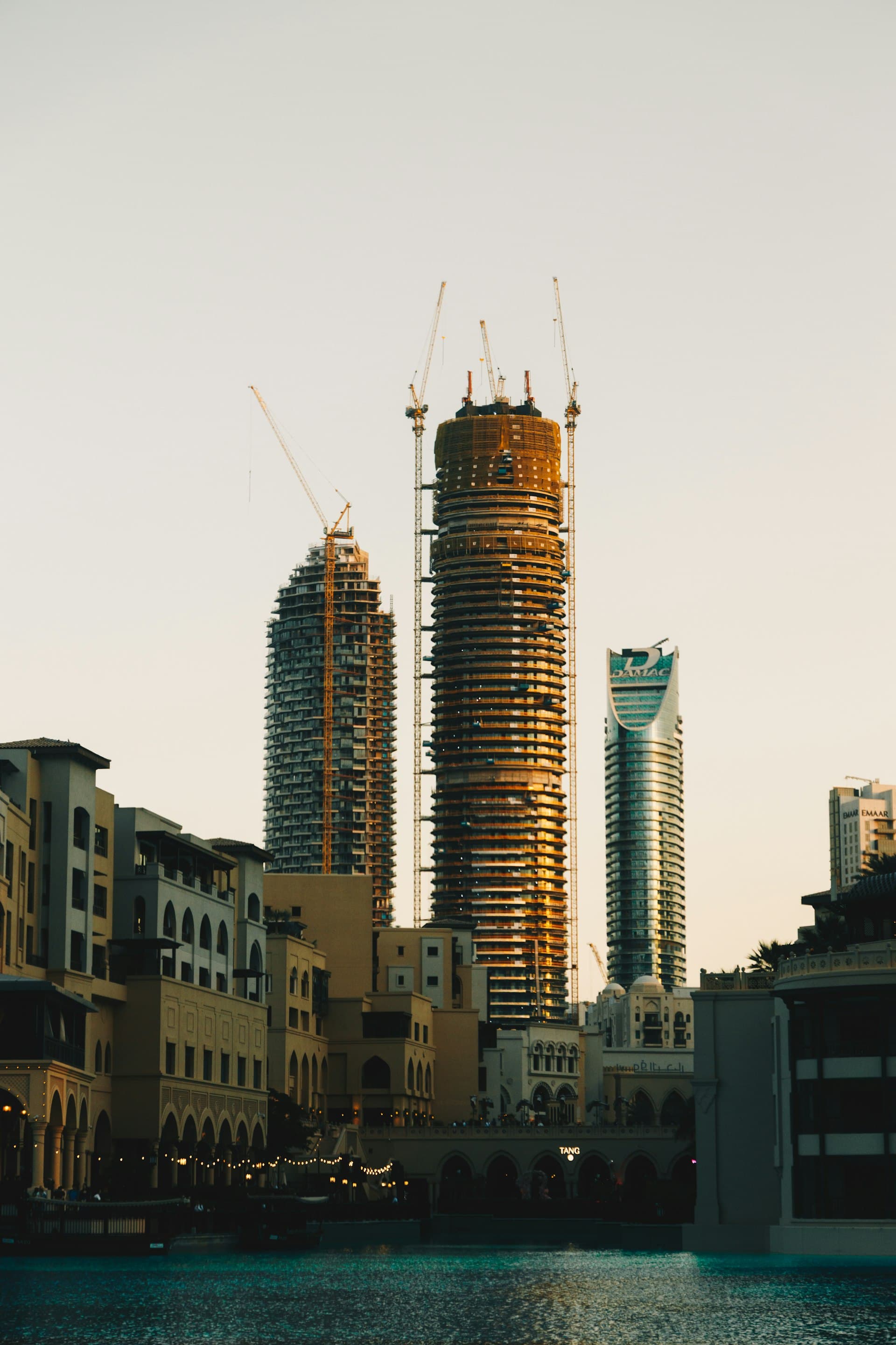 Towers under construction in a Gulf city at sunset